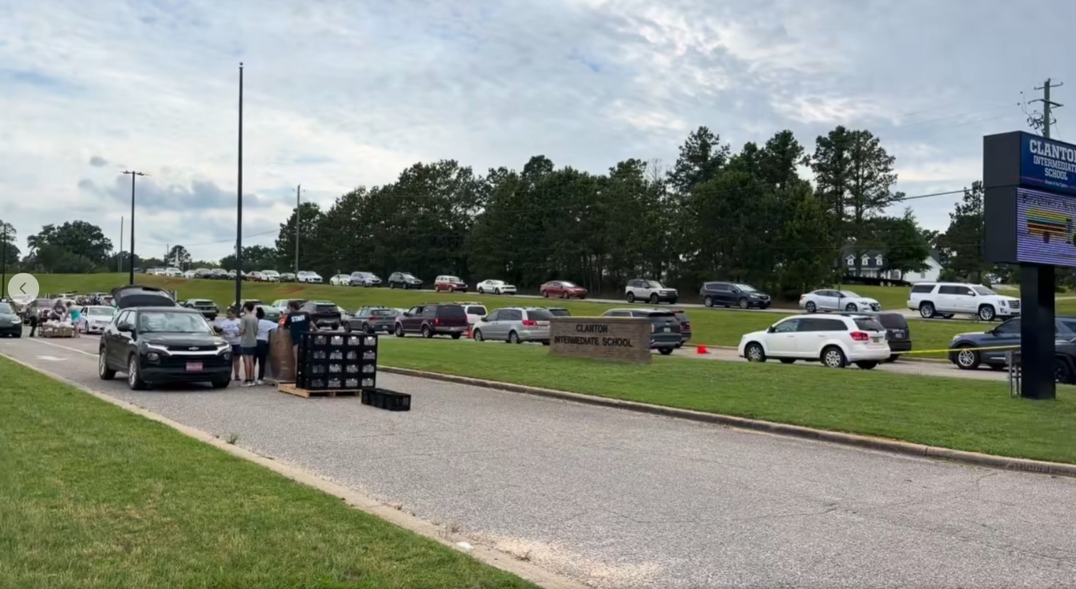 Cars lined up along the road outside Clanton Intermediate School for a Chilton County summer feeding meal pickup